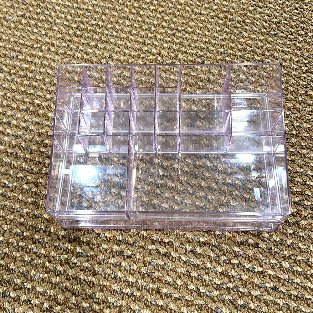 Makeup holder. Various compartments for storing makeup w/drawer underneath.